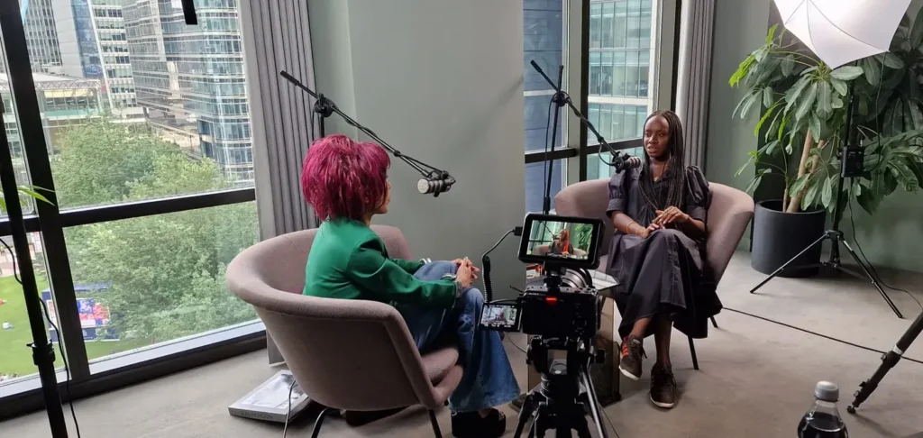 Pearl Lam and Alayo Akinkugbe filming an episode of The Pearl Lam Podcast